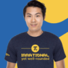 Asian man wearing Irrational Yet Well Rounded Pi tee